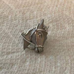 Silver horse pin and excellent condition and never worn.